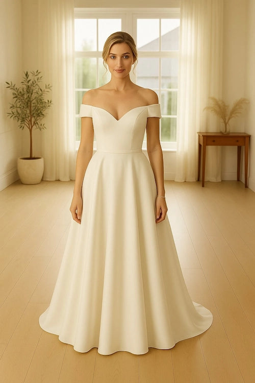 Woman wearing a white off-shoulder gown in a bright room, example of a extra style wedding gown clean