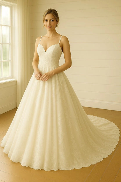 A woman modeling a white A-line wedding gown with thin spaghetti straps, a sweetheart neckline, and a full skirt with a long train - a typical example of a grande wedding dress clean